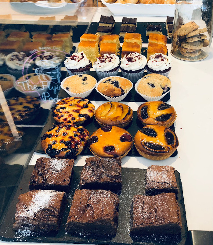 a selection of cakes in a cafe